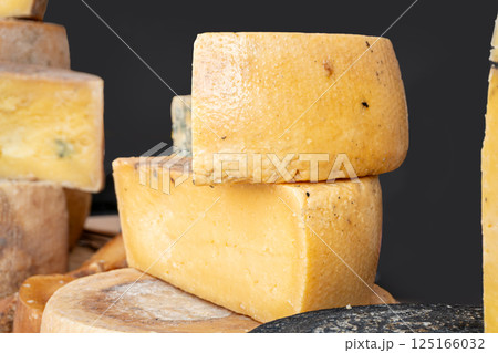 Assorted cheese varieties at a market stall Assorted cheese varieties at a market stall 125166032