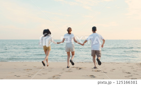 Happy friends holding hands running enjoy life funny and freedom on sand at beach together to sea in holiday vacation time at sunset, Young Asian group woman and man in summer travel, people lifestyle Happy friends holding hands running enjoy life funny and freedom on sand at beach together to sea in holiday vacation time at sunset, Young Asian group woman and man in summer travel, people lifestyle 125166381