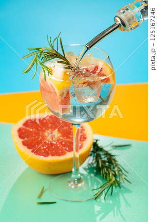 Refreshing summer cocktail with gin, tonic, grapefruit, and rosemary. Refreshing summer cocktail with gin, tonic, grapefruit, and rosemary. 125167246