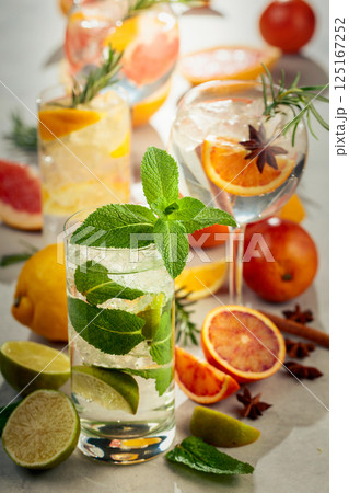 Refreshing summer cocktails with citrus on a white marble table. Refreshing summer cocktails with citrus on a white marble table. 125167252