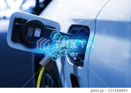 Power cable pump plug in charging power to electric vehicle EV car. Power cable pump plug in charging power to electric vehicle EV car. 125168045