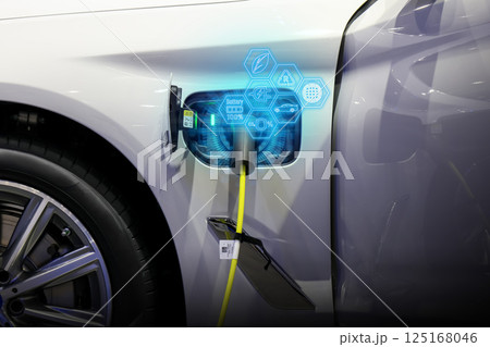Power cable pump plug in charging power to electric vehicle EV car. Power cable pump plug in charging power to electric vehicle EV car. 125168046