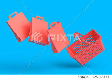 Shopping plastic basket for groceries with kraft paper bag on monochrome 125168131