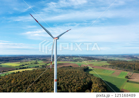 Drone aerial view of a single wind turbine in autumn scenery 125168489