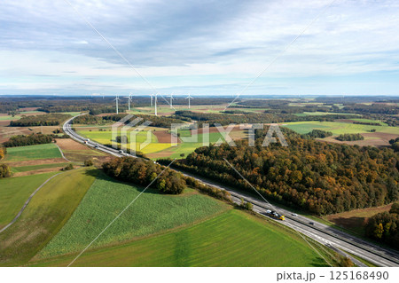 Drone image with a curved highway passing through an autumn forest, in Germany 125168490