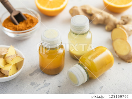 Immune ginger and turmeric energy shot drink with ginger root and turmeric powder 125169795