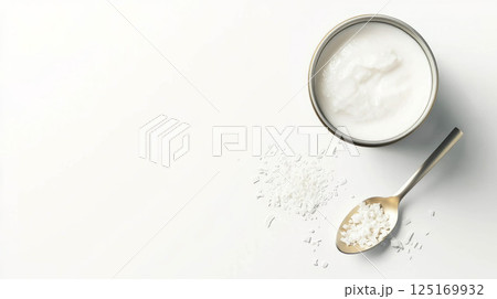 Fresh coconut milk in a can with shredded coconut garnish for culinary inspiration. 125169932