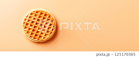 A round Belgian waffle with a golden-brown texture, placed against a clean background with copy space for text. Perfect for food banners, breakfast promotions 125170365