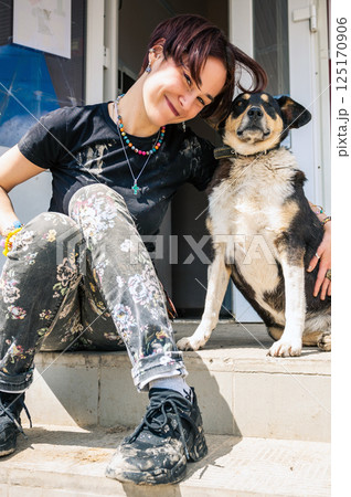 Dog in the shelter. Animal shelter volunteer takes care of dogs. Dog in the shelter. Animal shelter volunteer takes care of dogs. 125170906