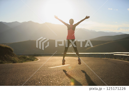 Fitness woman runner juping  in sunset 125171226