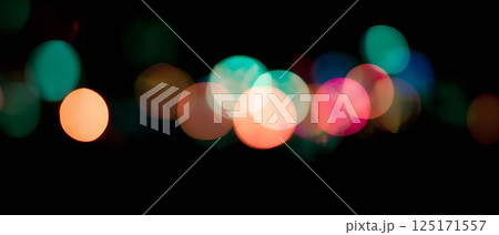 Delicate light bokeh with sharp angles creates a modern aesthetic on a dark backdrop. 125171557