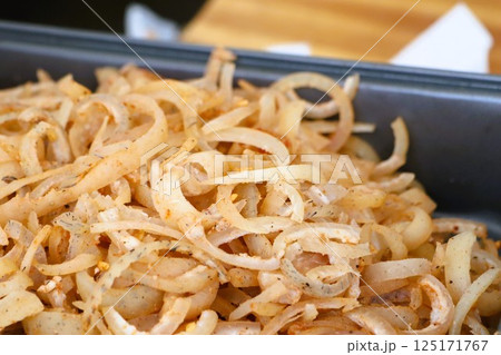 Pork skin, cut into thin strips, mixed with spices as an appetizer 125171767