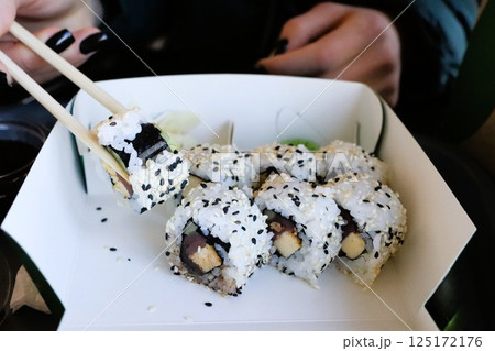 Enjoy delicious sushi rolls with nutritious black sesame seeds, delightful and appealing 125172176