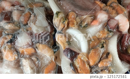 A delicious Frozen Seafood Medley meticulously prepared with Mussels and Squid delights the palate 125172581