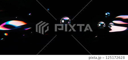 Bubbles display a rainbow gradient and smooth color transitions on a dark backdrop. 125172628