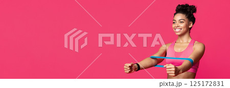 Sporty smiling black woman doing stretching work out with elastic bands, squating over red studio background, panorama with copy space Sporty smiling black woman doing stretching work out with elastic bands, squating over red studio background, panorama with copy space 125172831