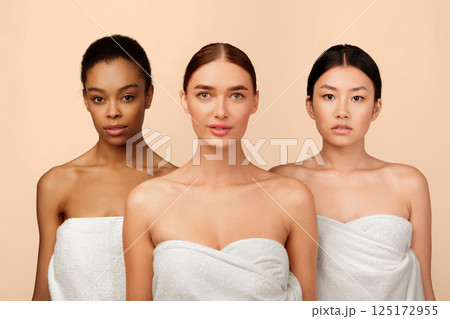 Three Multiethnic Sensual Women In Bath Towels Posing Over White Studio Background. Body And Skincare. 125172955