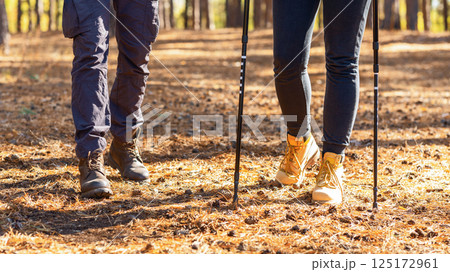 Two friends legs walking by autumn forest, closeup 125172961