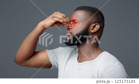 Overworked afro man touching his nose bridge, suffering from eye pain, tired eyes Overworked afro man touching his nose bridge, suffering from eye pain, tired eyes 125173185