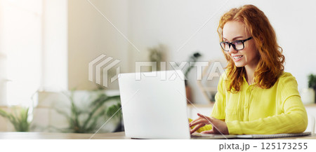 Working At Home. Smiling young female manager in glasses typing on computer, sending email, free space Working At Home. Smiling young female manager in glasses typing on computer, sending email, free space 125173255