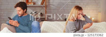 Modern Relationship Problem. Couple Using Smartphones Sitting On Sofa Ignoring Each Other At Home In Evening. Panorama Modern Relationship Problem. Couple Using Smartphones Sitting On Sofa Ignoring Each Other At Home In Evening. Panorama 125173362