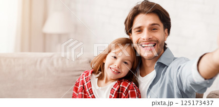 Portrait of smiling father and daughter taking selfie together, close up Portrait of smiling father and daughter taking selfie together, close up 125173437