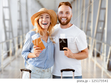 Travelling concept. Happy couple with passports and tickets at airport terminal 125173541