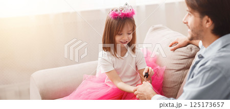 You are best dad. Little pretty princess coloring her dad nails with colorful polisher, close up 125173657