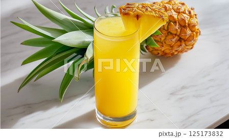 Refreshing pineapple juice served in a tall glass garnished with a slice of pineapple 125173832
