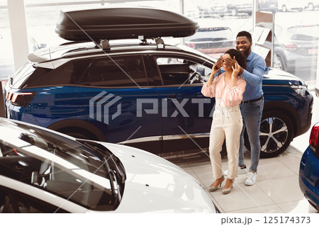 Own Car. African Amrerican Husband Covering Wife's Eyes Showing Her New Auto In Dealership Store. Empty Space Own Car. African Amrerican Husband Covering Wife's Eyes Showing Her New Auto In Dealership Store. Empty Space 125174373