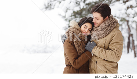 Winter Love. Cute Lovers Embracing Standing In Snowy Forest Having Date Outdoor. Copy Space, Panorama 125174428