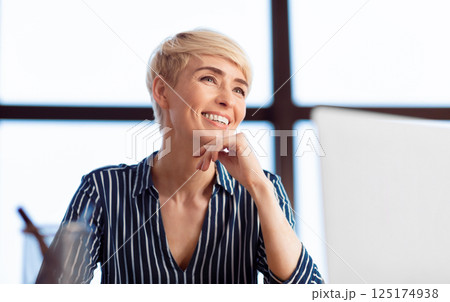 Successful Businesswoman. Happy Lady Sitting At Workdesk Smiling Working In Modern Office. Selective Focus Successful Businesswoman. Happy Lady Sitting At Workdesk Smiling Working In Modern Office. Selective Focus 125174938