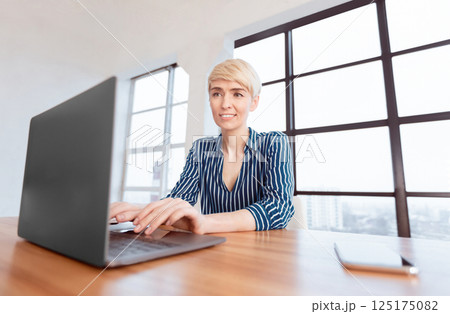 Business Woman Working On Laptop Computer Sitting In Modern Office. Successful Entrepreneur Career. Low-Angle, Selective Focus 125175082