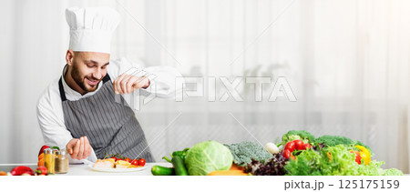 Cooking Fish. Male Chef Seasoning Roasted Salmon Steak Standing In Kitchen. Selective Focus 125175159