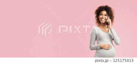 Excited pregnant woman talking on smartphone, having pleasant conversation on pink background, copy space Excited pregnant woman talking on smartphone, having pleasant conversation on pink background, copy space 125175813