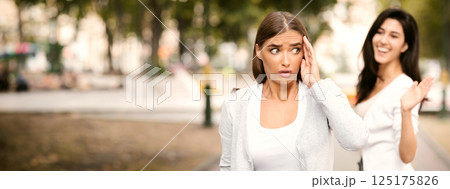 Toxic People. Girl Avoiding Meeting Tiresome Female Friend Pretending Not Noticing And Ignoring Greeting Walking Outdoors. Selective Focus 125175826