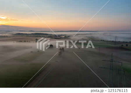 Sunrise aerial view in a german village on a foggy morning 125176115