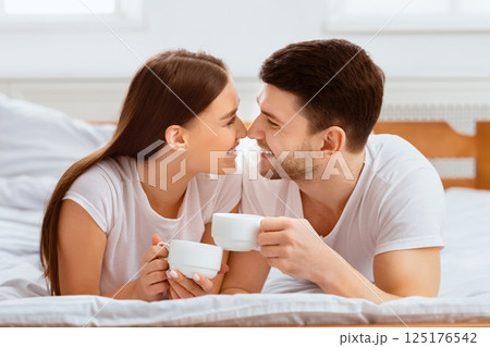 Weekend Together. Loving Couple Having Morning Coffee Lying In Bed At Home. 125176542