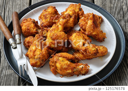 crispy fried chicken wings on a plate 125176578