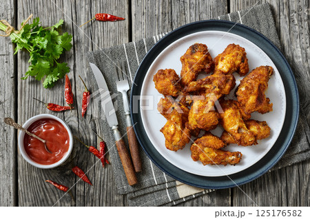 crispy fried chicken wings on a plate 125176582