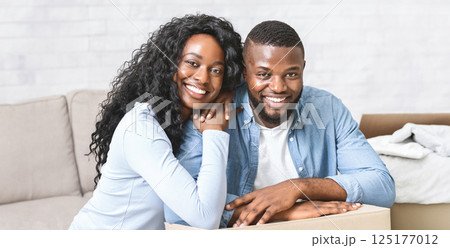 New life in new house. Young happy african american couple embracing at new apartment, copy space New life in new house. Young happy african american couple embracing at new apartment, copy space 125177012