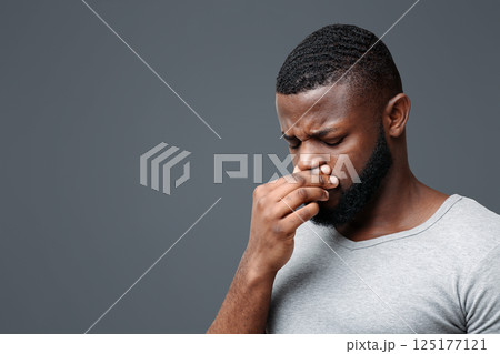 Afro guy touching his nose, having runny nose, suffering from seasonal allergy, copy space 125177121