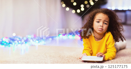 I wanted doll. Sad african little girl with unwanted Christmas gift cellphone, free space I wanted doll. Sad african little girl with unwanted Christmas gift cellphone, free space 125177175