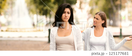 End Of Friendship. Two Girls Friends Having Quarrel Walking In Park Outdoors. Selective Focus End Of Friendship. Two Girls Friends Having Quarrel Walking In Park Outdoors. Selective Focus 125177681