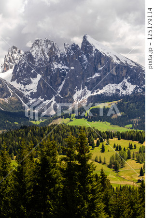 Majestic mountain landscape with snow-capped peaks and green valleys near Valley of Funes at Dolomites, Italy 125179114