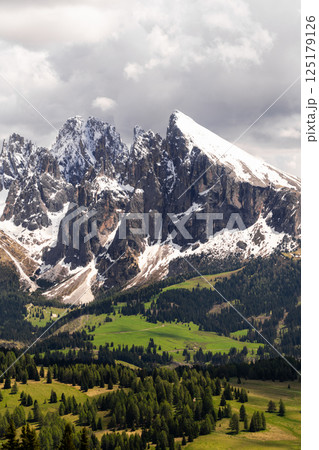 Majestic mountain range with snow-covered peaks under dramatic sky near Valley of Funes at Dolomites, Italy Majestic mountain range with snow-covered peaks under dramatic sky near Valley of Funes at Dolomites, Italy 125179126