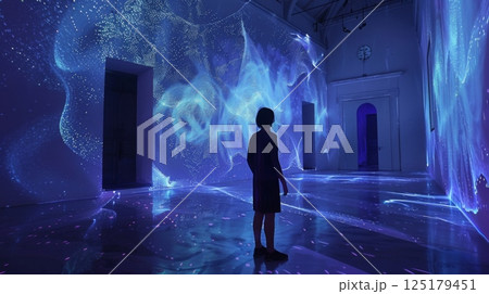 A person stands in a room with blue lights projected onto the walls and floor. The light creates a dynamic and abstract pattern. 125179451