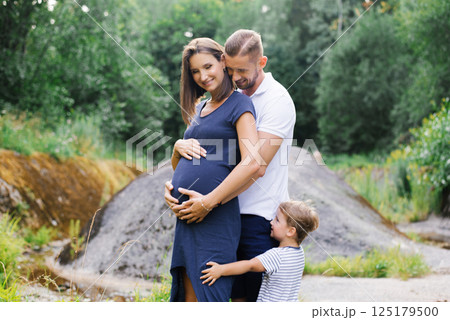 Family With Pregnant Mom And Child Outdoors Together Family With Pregnant Mom And Child Outdoors Together 125179500