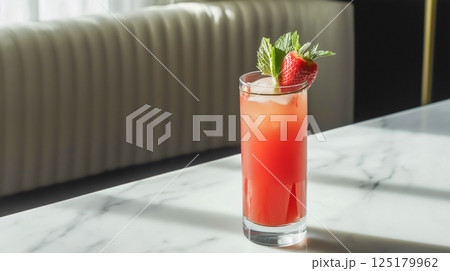 Refreshing strawberry juice served in a glass with mint leaves garnishing for a vibrant summer drink experience 125179962