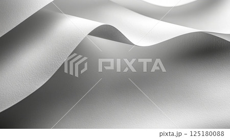 Smooth white fabric undulates softly, catching light in gentle waves, creating an elegant and serene atmosphere perfect for showcasing textiles. 125180088